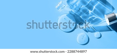 pipette drop of serum test on a blue background sun glare