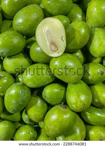 Closeup top view green small mango for sell in the market.this photo was taken from Bangladesh.