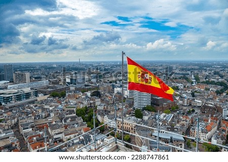 View from the top of the Domtoren - Church tower. Spain flag flying as Utrecht hosted Vuelta a España bicycle race. Spanish flag flying in the wind over Dutch city view. 
