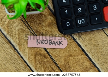 Concept of Neobank write on sticky notes isolated on Wooden Table.