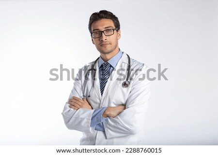 Portrait of young handsome doctor in medical gown and stethoscope isolated on white background Royalty-Free Stock Photo #2288760015