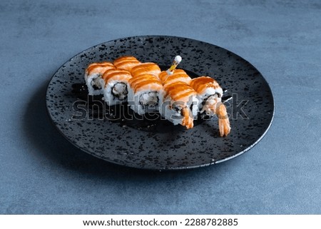 Uramaki Tiger with fish and rice, preparation with Japanese Sushi technique. Royalty-Free Stock Photo #2288782885