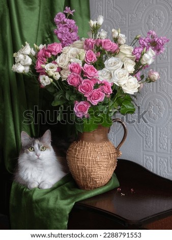 Adorable cat and bouquet of flowers
