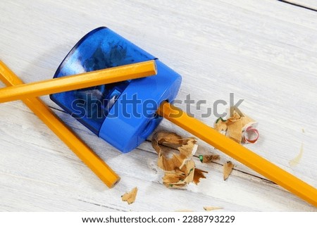 pencil sharpener and yellow color pencil with shavings