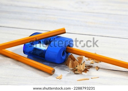 pencil sharpener and yellow color pencil with shavings