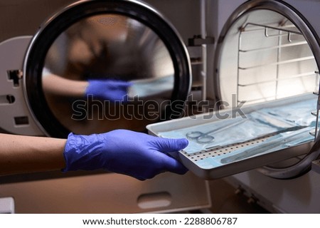Side view the process of sterilizing medical instruments in an autoclave Royalty-Free Stock Photo #2288806787