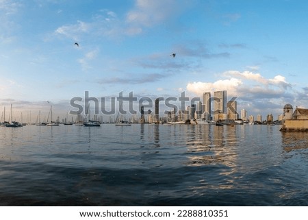Panoramic View of Manga Island Marina with Several Small Boats and City Skyline and Clear Blue Sky in the Background in Cartagena, Bolivar, Colombia