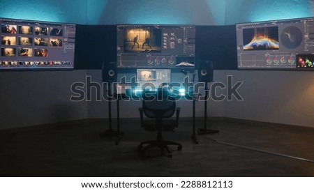 Studio with modern equipment for color correction. Computer, digital tablet and big screens showing color grading program interface with movie footage, RGB graphics and color wheels. Post production. Royalty-Free Stock Photo #2288812113