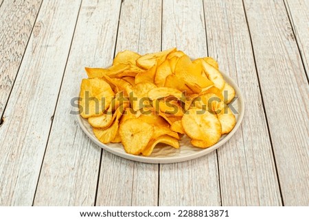 Crisp potatoes are served in the shape of a flat disk or circle, basically the shape of a potato slice lengthwise. In western countries, they are a very important part of the snack market