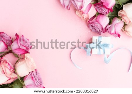 wedding or mothers day background, bouquet over plain pink background, gift box