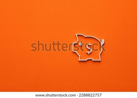 Dollar sign inside piggy bank on orange color background - Money icon with a dollar sign, graphic resource for design