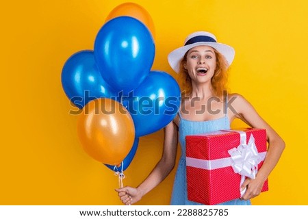 laughing birthday woman with present in studio. birthday woman with present