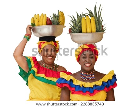 Happy smiling fresh fruit street vendors aka Palenqueras of Cartagena, Colombia, isolated on white background. Cheerful Afro-Colombian women in traditional clothing, Colombian culture and lifestyle. Royalty-Free Stock Photo #2288835743