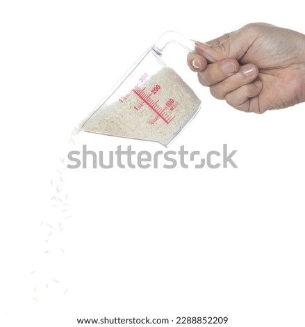 Japanese Rice fall, white grain rices pouring down abstract cloud fly from measuring Cup. Beautiful complete seed rice in air, food object design. Selective focus freeze shot white background isolated