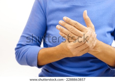 Hand of a woman suffering from hand pain on white background. Healthcare and office syndrome concept.