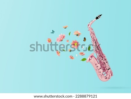 Composition made of pink saxophone retro style with colorful summer flowers and green leaves against pastel blue background. Minimal nature concept.Trendy collage, creative art minimal aesthetic