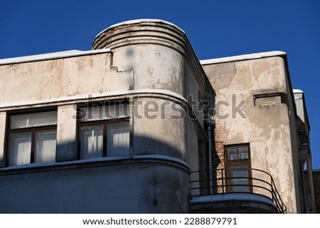 the stepped facade of an old building with a rounded corner