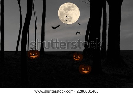 Silhouette of a devilish pumpkin on the floor in the forest at night with crows flying in full moon night.