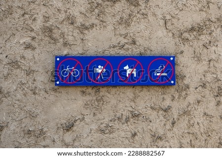 Signs: no cycling, no photography, no dog walking, no smoking
