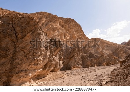 Golden Canyon trailhead with scenic view of colorful geology of multi hued Amargosa Chaos rock formations, Death Valley National Park, Furnace Creek, California, USA. Barren Artist Palette landscape Royalty-Free Stock Photo #2288899477
