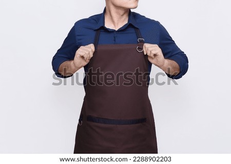 Asian Man wearing Apron in casual stylish clothing, standing tall pose with both hands straightening his apron, ready to work gesture, no face isolated white background Royalty-Free Stock Photo #2288902203