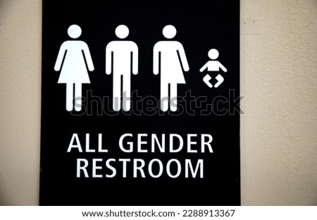 All Gender Restroom Sign with graphic characters including a baby.