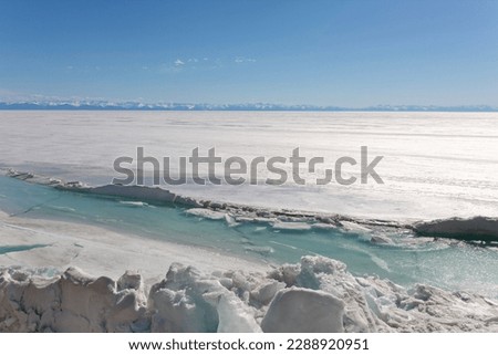 Frozen Lake and Snowy Mountains Winter Landscape