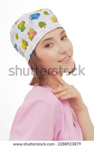 Catalog headshots of surgical scull hat, young female health professional posing on white background in studio. Kids Dentist headwear photo shoot. Royalty-Free Stock Photo #2288923879