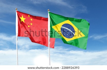 China flag and Brazil flag on cloudy sky. waving in the sky Royalty-Free Stock Photo #2288926393