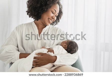 Close up portrait of beautiful young African American  mother holding sleep newborn baby in hospital bed room. Healthcare medical love black afro woman lifestyle mother's day, breast with copy space.  Royalty-Free Stock Photo #2288936869