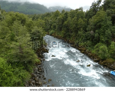 river surrounded by trees with cloudy weather