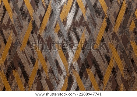 The surface of the textured wallpaper with a grey-brown graphic pettern. Modern trends in decor and interior design. Close-up. Royalty-Free Stock Photo #2288947741