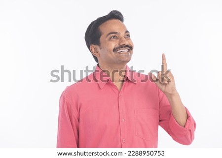 Portrait of businessman pointing away hands together and showing or presenting something