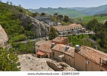 group of cyclists climbs the hill in single file entering a town in central Sicily Royalty-Free Stock Photo #2288951049