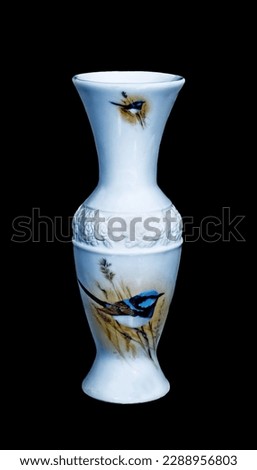 White coloured Decorative Ceramic Vase isolated on a black background with a Blue Wren bird pictured. JPG image for Graphics and Craft artwork.