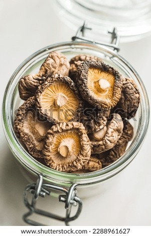 Dried shiitake mushrooms in jar on the kitchen table. Royalty-Free Stock Photo #2288961627