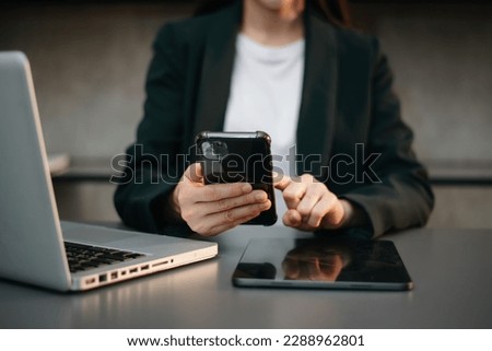 Businesswoman hand using laptop, tablet and smartphone in office. Digital marketing media mobile app and discussing plan new start up project. Finance task.
 Royalty-Free Stock Photo #2288962801