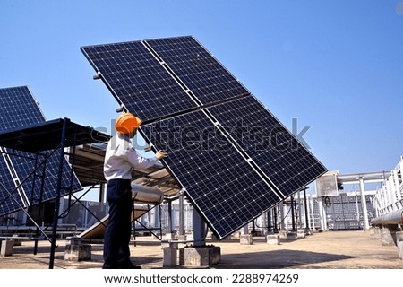 Asian male engineer checking the solar panel installation at the solar power station. Concept of alternative energy and power sustainable resources. Royalty-Free Stock Photo #2288974269