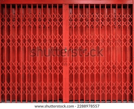 Traditional folding red metal door gate