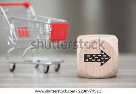 Wooden block with symbol of influencer concept and trolley on background