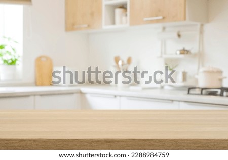 Kitchen table top for product display with blurred modern interior Royalty-Free Stock Photo #2288984759