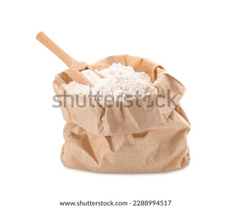 Paper bag with wheat flour and wooden scoop isolated on white background Royalty-Free Stock Photo #2288994517
