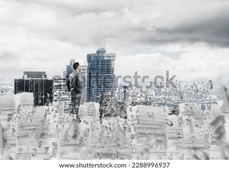 Confident young businessman in suit standing among flying letters with cityscape on background. Mixed media. Royalty-Free Stock Photo #2288996937