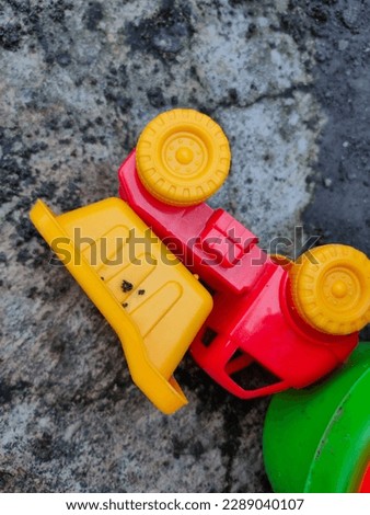 Colorful plastic children's toys in the sand. Concept of sand for children. Top view. Space for text. Flat lay, top view, copy space