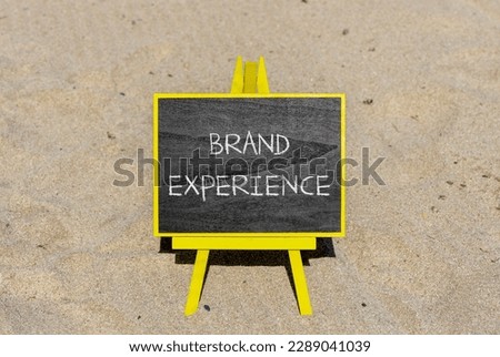 Brand experience symbol. Concept words Brand experience on black chalk blackboard on a beautiful sand beach background. Business branding and brand experience concept. Copy space.