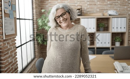 Middle age woman with grey hair business worker smiling confident at office
