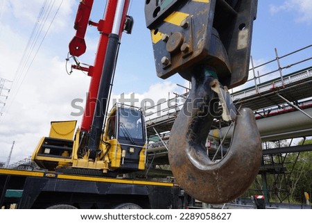 Close up crane hook for mobile crane in construction site and background is a scaffolding at chemical plant Industrial estate.                                Royalty-Free Stock Photo #2289058627