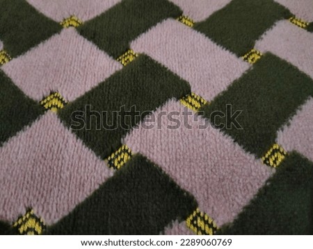 a fur rug that has a gingham pattern in cream green and yellow