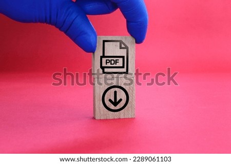 wooden square with PDF format file icon and download. the concept of saving a pdf file. concept pdf file format