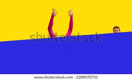 Curious, interested, young man looking out blue background and peeping at female legs in red tights and heels sticking out vivid yellow background. Concept of secrets, relationship, social life.